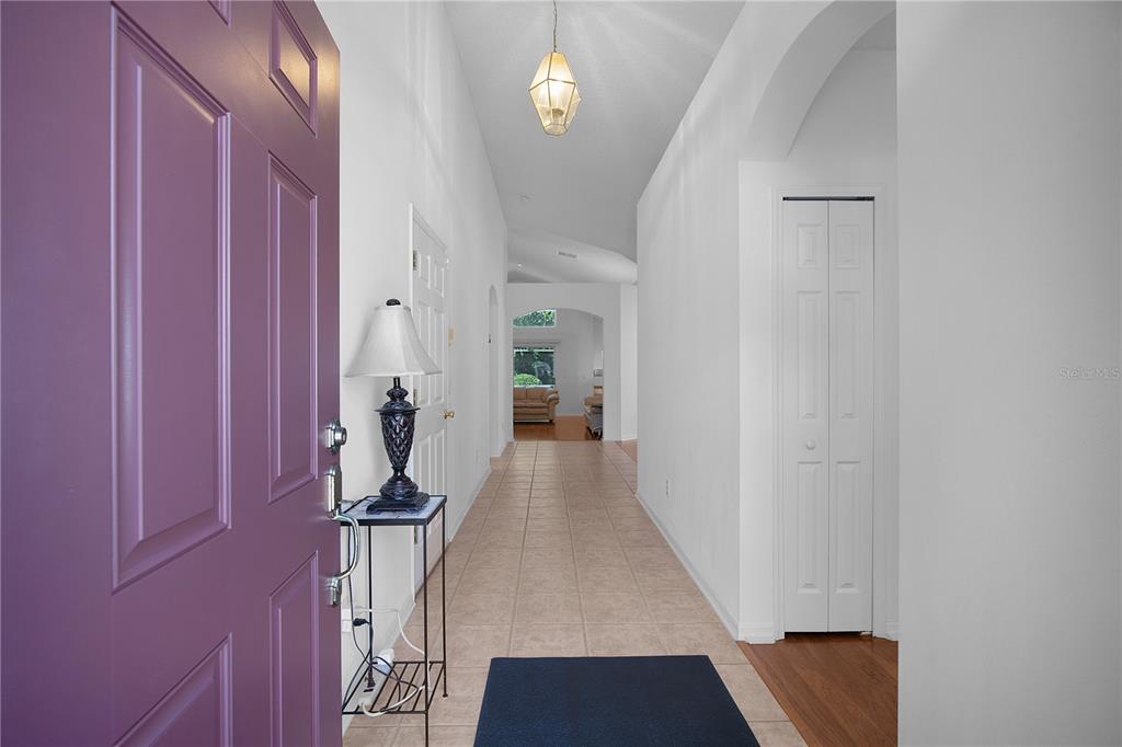 A purple front door opens into a tiled entryway with a hallway leading further inside — 839 MATTOCKS COURT, CASSELBERRY, FL