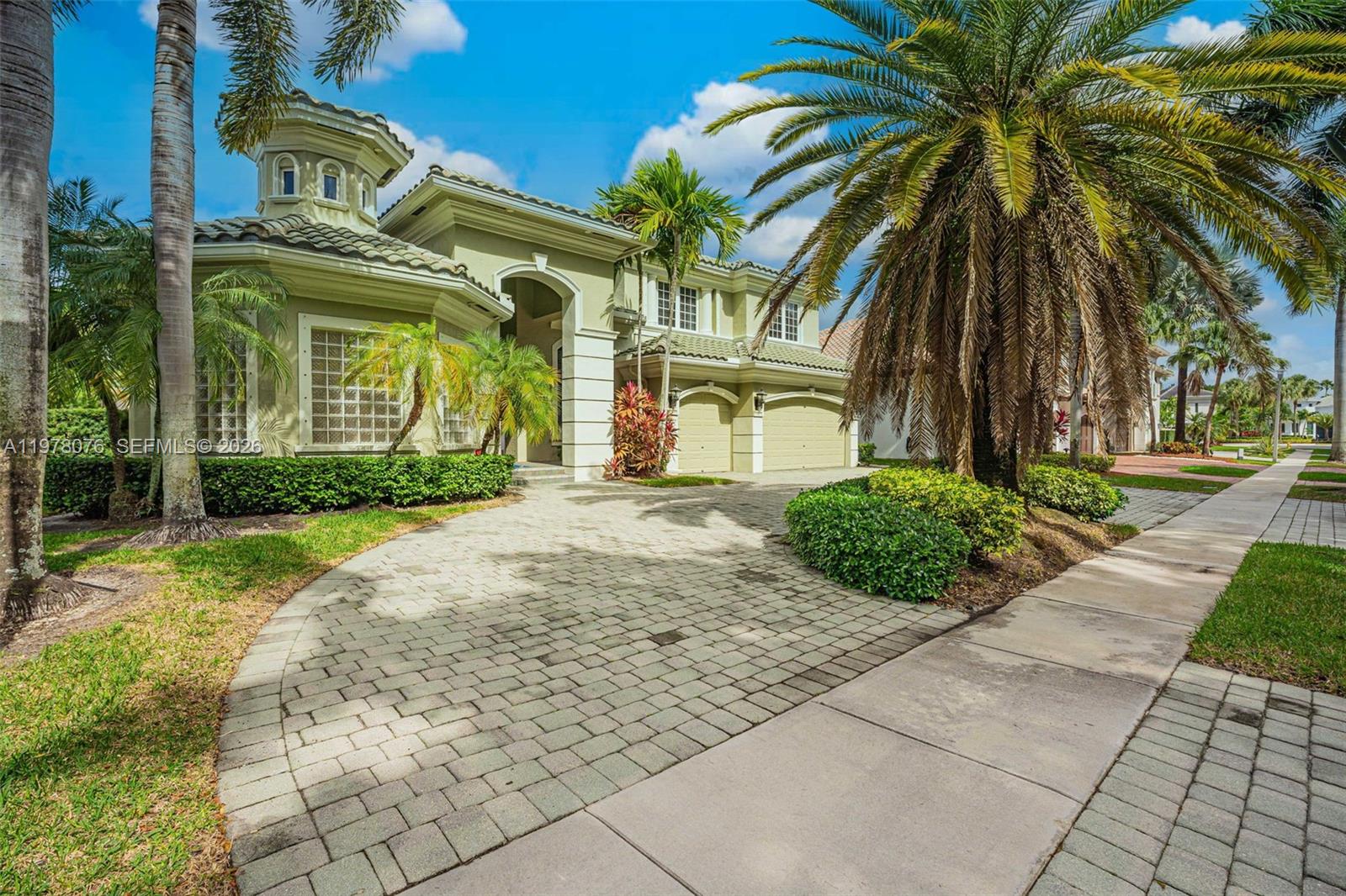 A two-story house with a paved driveway, palm trees, and a two-car garage — 10221 Blue Palm St, Plantation FL 33324, PLANTATION, FL