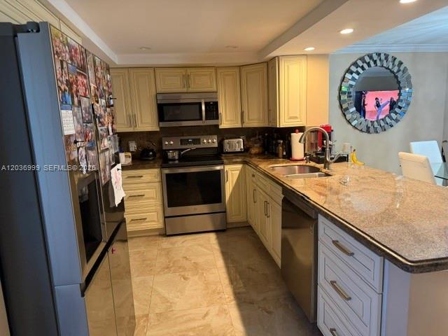 A kitchen features light wood cabinets, stainless steel appliances, and a granite countertop island — 101 SE 3rd Ave # 506, Dania Beach FL 33004, DANIA BEACH, FL
