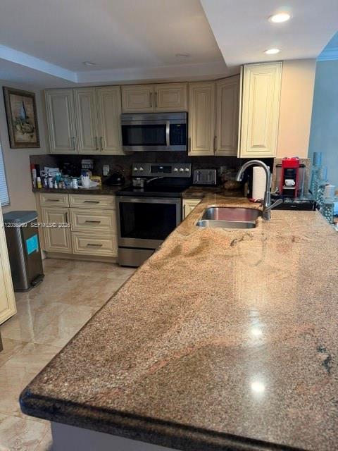 A kitchen features light-colored cabinetry, granite countertops, and stainless steel appliances — 101 SE 3rd Ave # 506, Dania Beach FL 33004, DANIA BEACH, FL