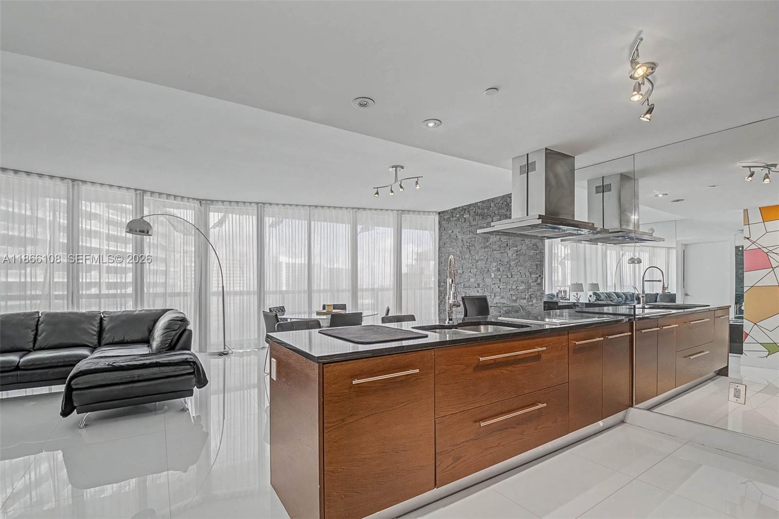 A view of modern high-rise apartment buildings along a waterfront in a city — 495 Brickell Ave # 3504, Miami FL 33131, MIAMI, FL