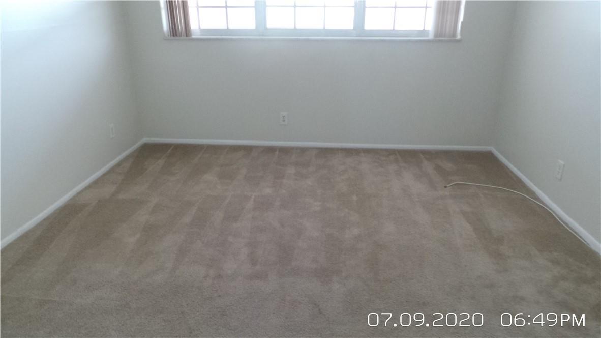 An empty room features beige wall-to-wall carpeting, white walls, and a window with blinds — 2651 S Course Drive # 403, Pompano Beach FL 33069, POMPANO BEACH, FL
