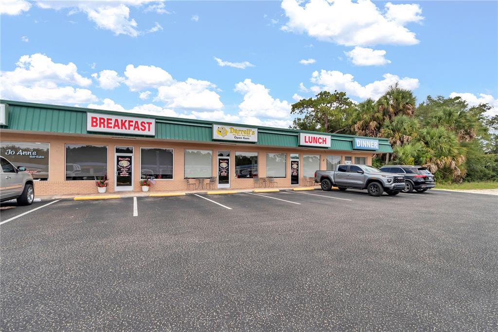 A single-story commercial strip mall building with a parking lot in front — 963 N SUNCOAST BOULEVARD, CRYSTAL RIVER, FL