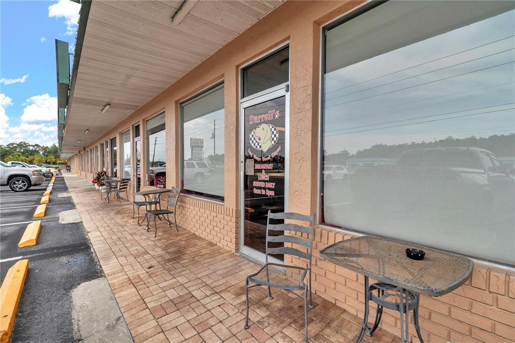 An exterior view of a restaurant storefront with outdoor seating on a brick sidewalk — 963 N SUNCOAST BOULEVARD, CRYSTAL RIVER, FL
