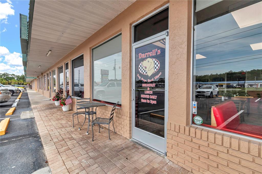 An exterior view of a restaurant entrance with a small table and chairs outside — 963 N SUNCOAST BOULEVARD, CRYSTAL RIVER, FL