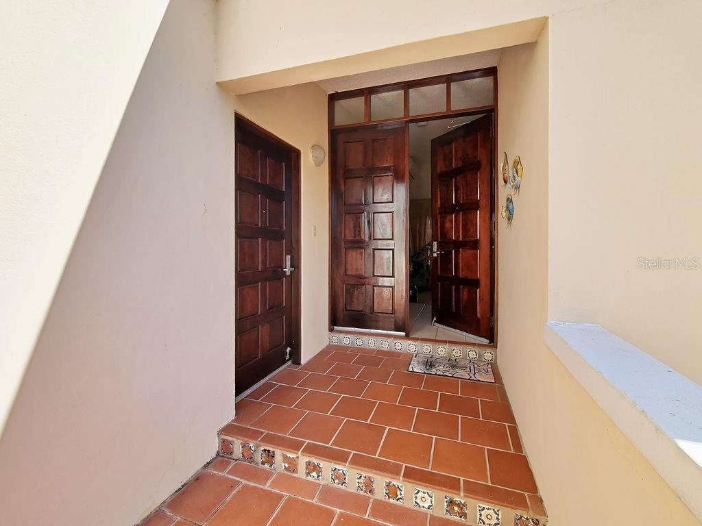 An exterior entryway features a tiled floor, a single door, and a double door entrance — 150 CANDELERO DRIVE UNIT 798, HUMACAO, PR