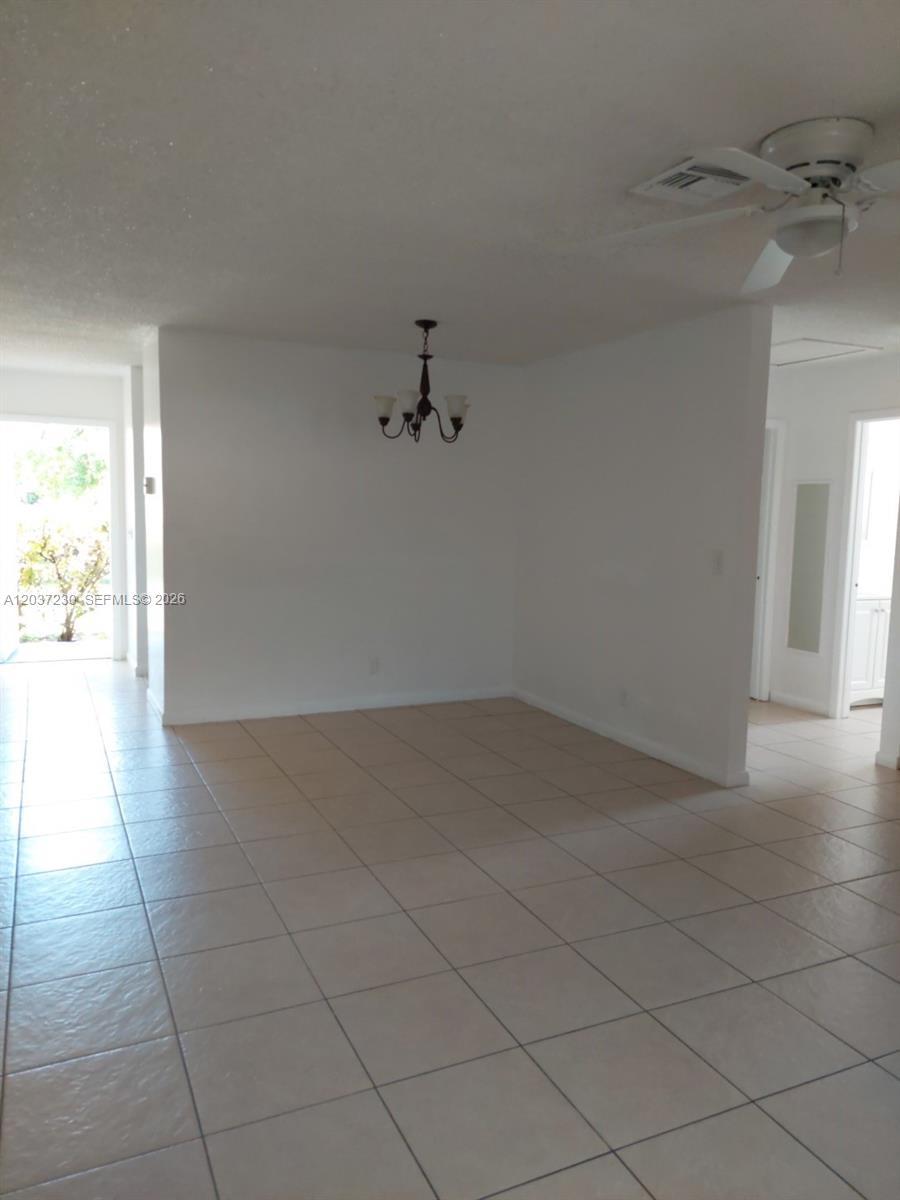 A dining area with tile floors, a chandelier, and a ceiling fan is visible — 2319 Johnson St # 1, Hollywood FL 33020, HOLLYWOOD, FL