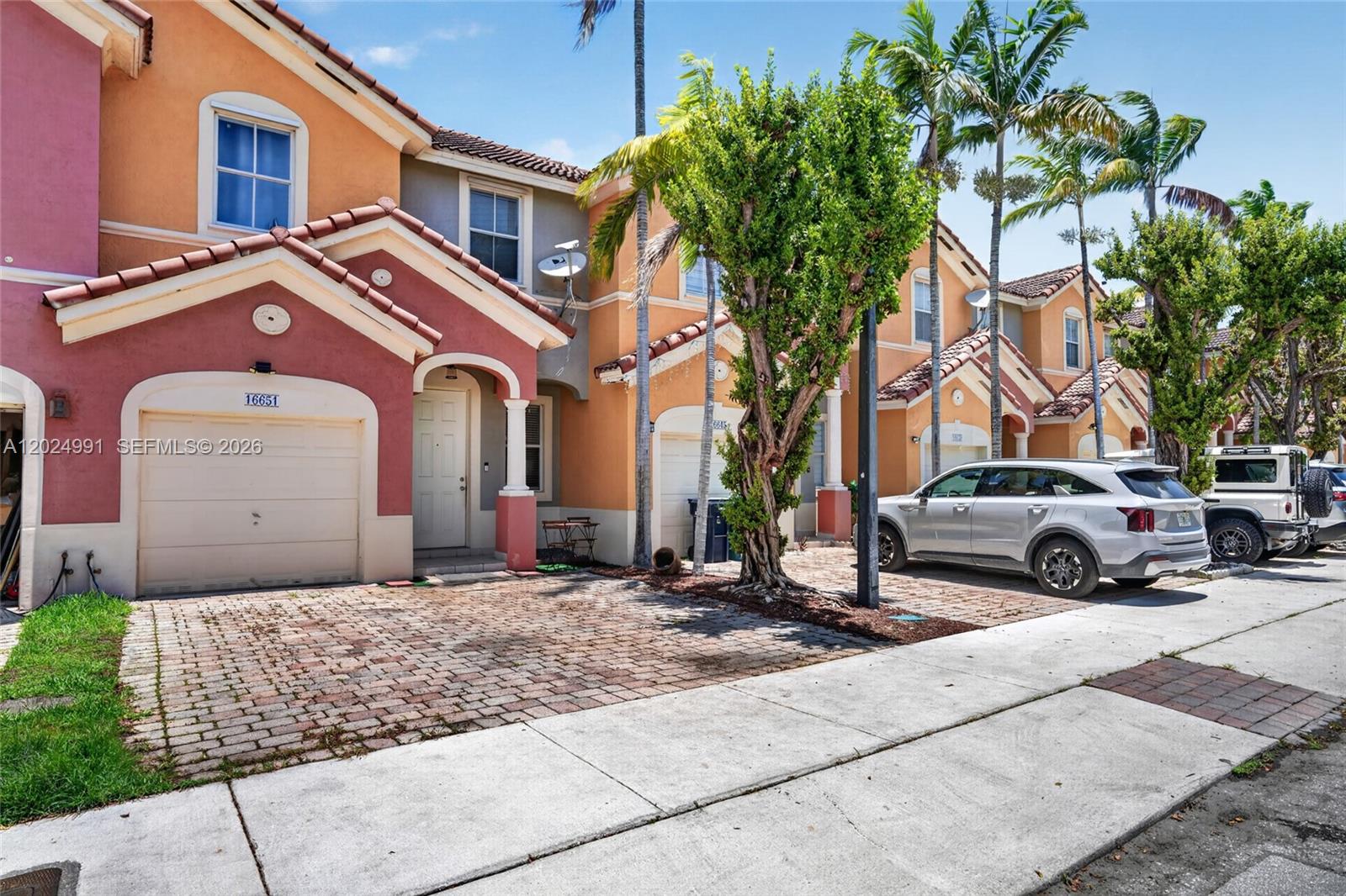A row of multi-story townhomes features brick driveways, stucco facades, and palm trees — 16651 SW 79th Ter, Miami FL 33193, MIAMI, FL