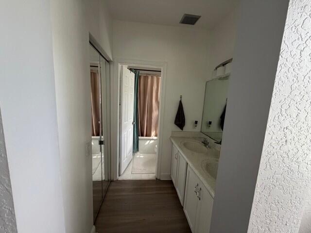 A bathroom features a double vanity with white cabinets, a mirror, and a separate room — 3013 Laurel Ridge Circle, Riviera Beach FL 33404, RIVIERA BEACH, FL
