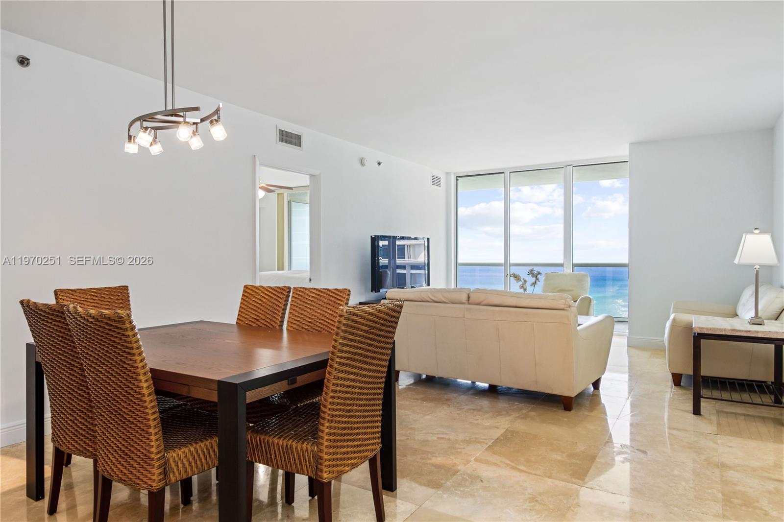A dining area and living room with ocean views and tile flooring — 1830 S Ocean Dr # 4204, Hallandale Beach FL 33009, HALLANDALE BEACH, FL