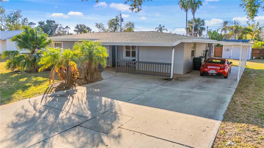 A single-story house with a concrete driveway, a covered carport, and a front porch — 524 SARABAY ROAD, OSPREY, FL