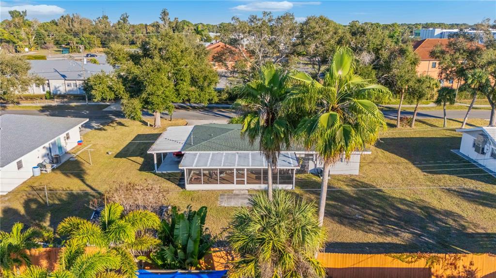 An aerial view shows a single-story house with a green roof and a screened-in porch — 524 SARABAY ROAD, OSPREY, FL