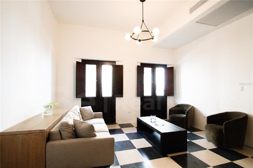 A living room features a black and white checkered floor, a sofa, and two armchairs — 254-256 SAN FRANCISCO STREET UNIT 201, SAN JUAN, PR