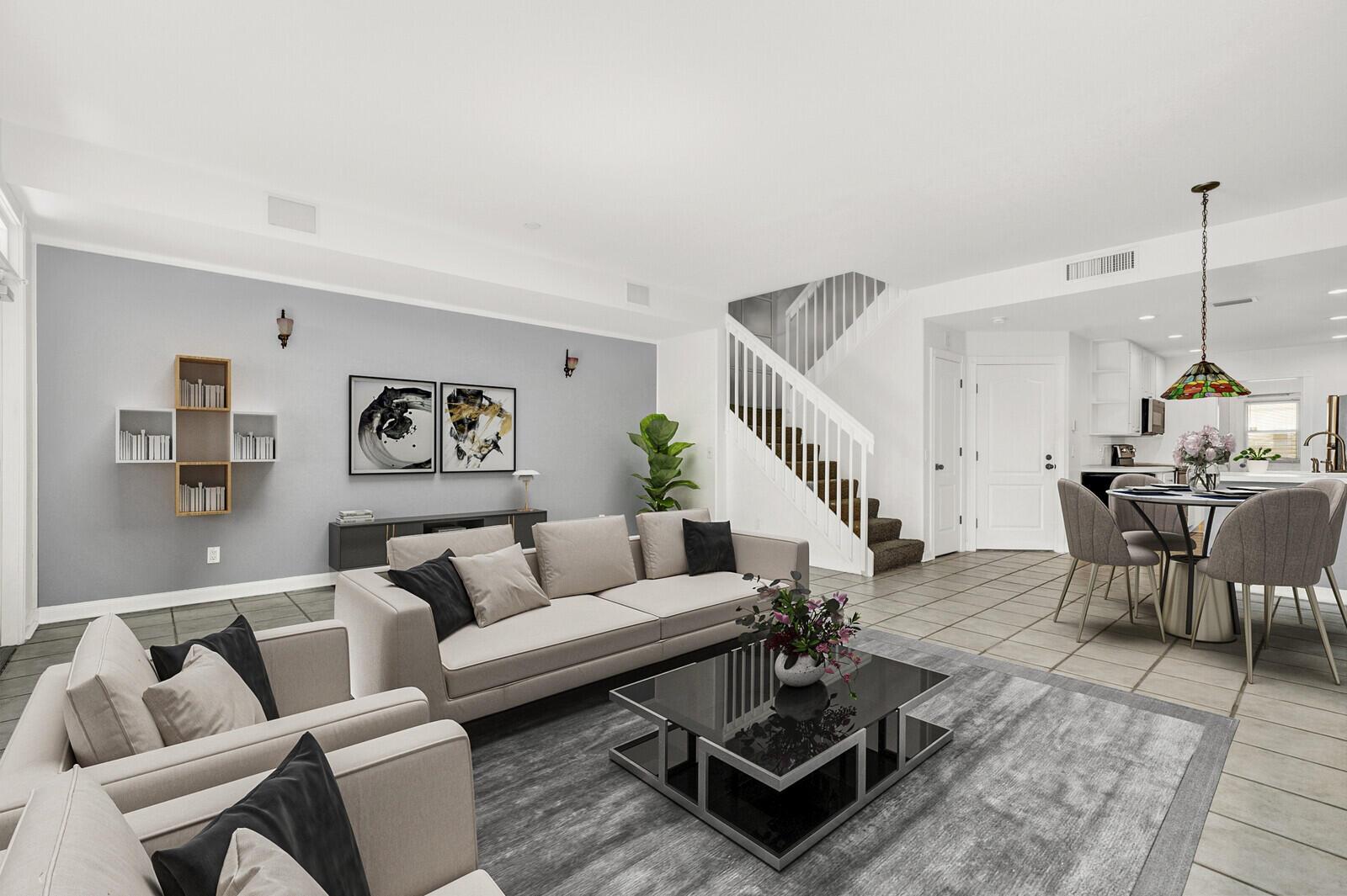 A living room features a grey sofa, a glass coffee table, and an adjacent dining area — 133 Wentworth Court, Jupiter FL 33458, JUPITER, FL