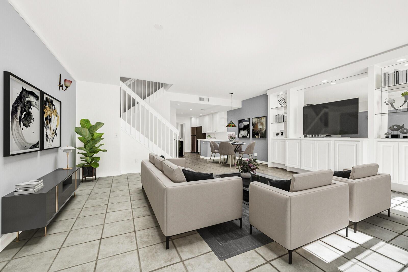 A living room with tile floors, a staircase, and a built-in media center with shelving — 133 Wentworth Court, Jupiter FL 33458, JUPITER, FL