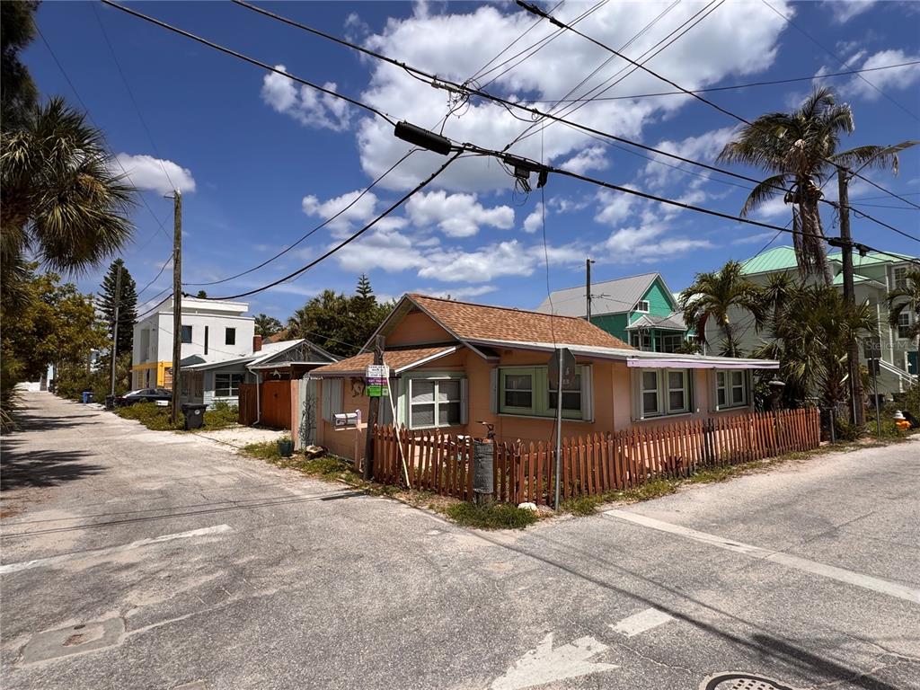 A small, peach-colored house with a brown roof sits on a corner lot — 101 95TH AVENUE, TREASURE ISLAND, FL