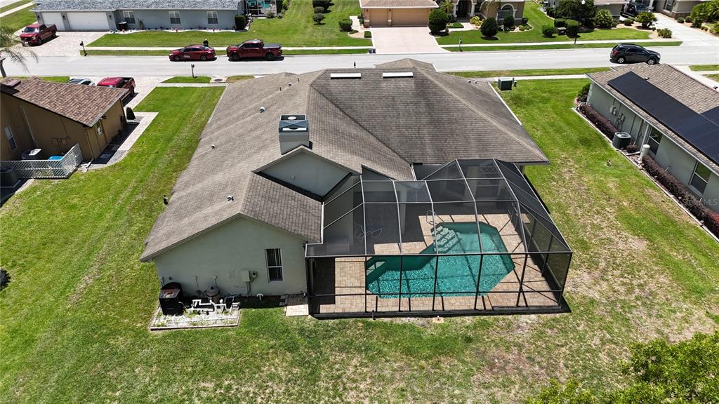 An aerial view of a suburban house featuring a screened-in pool and patio area — 4072 MISTY VIEW DRIVE, SPRING HILL, FL