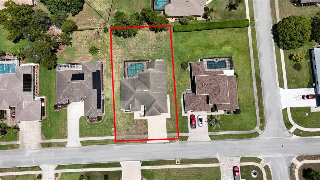 An aerial view shows a single-family home with a pool and a large backyard — 4072 MISTY VIEW DRIVE, SPRING HILL, FL
