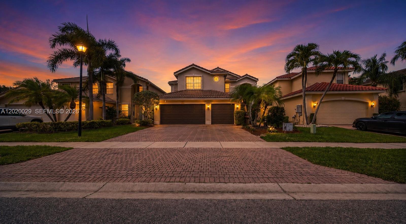 A two-story house with a backyard pool, patio, and lounge chairs at sunset — 9985 Marsala Way, Delray Beach FL 33446, DELRAY BEACH, FL