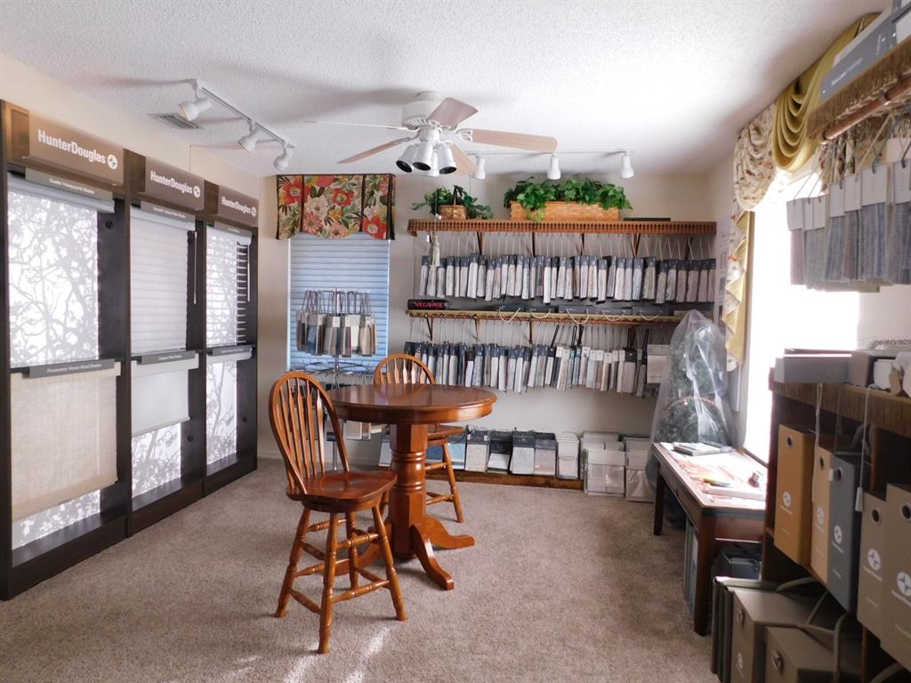 A showroom features Hunter Douglas window treatment displays, fabric sample racks, and a wooden table — 4655 N CARL G. ROSE HIGHWAY, HERNANDO, FL