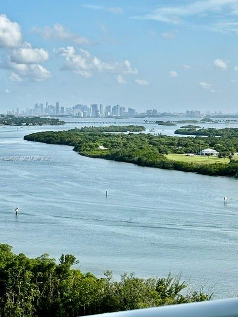 An elevated view of a bay with a distant city skyline and lush green islands — 100 Bayview Dr # 2124, Sunny Isles Beach FL 33160, SUNNY ISLES BEACH, FL