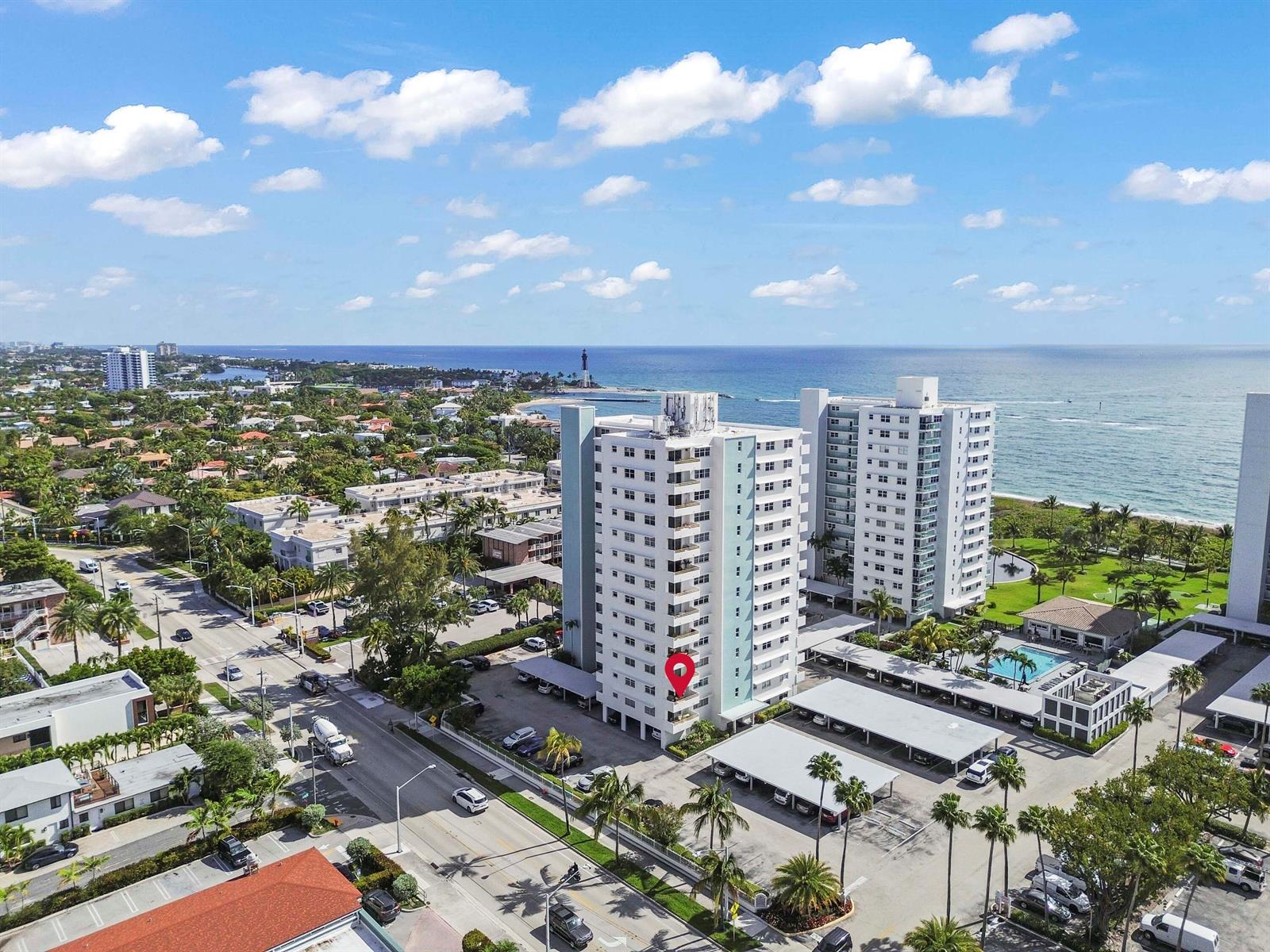 An aerial view shows a tall residential building with a red location pin near the ocean — 1630 N Ocean Boulevard # 215, Pompano Beach FL 33062, POMPANO BEACH, FL