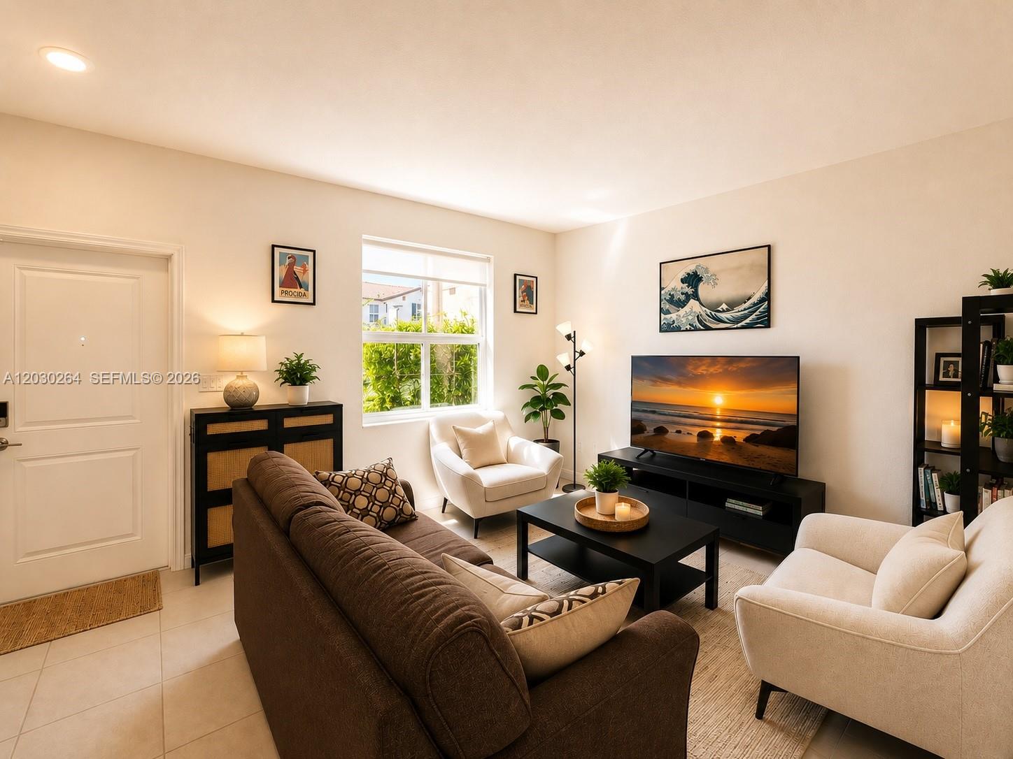 A living room features a brown sofa, two cream armchairs, a television, and a window — 12159 NW 23rd Ct # 12159, Miami FL 33167, MIAMI, FL