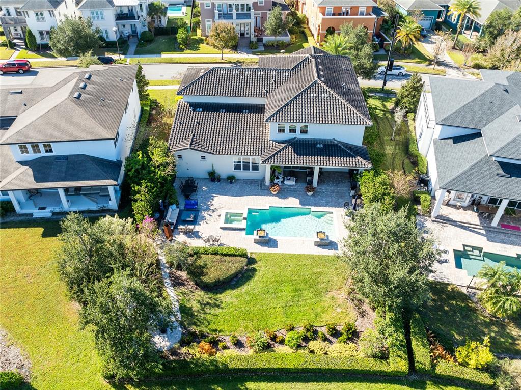 An aerial view shows a two-story house with a swimming pool and backyard patio — 14153 CORRIGAN AVENUE, ORLANDO, FL