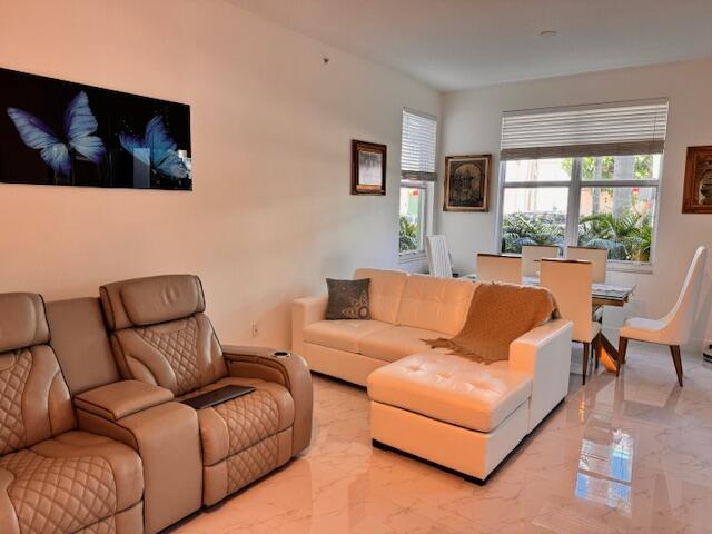 A living and dining area features beige leather recliners, a white sectional, and tile floors — 804 E Windward Way # 103, Lantana FL 33462, LANTANA, FL