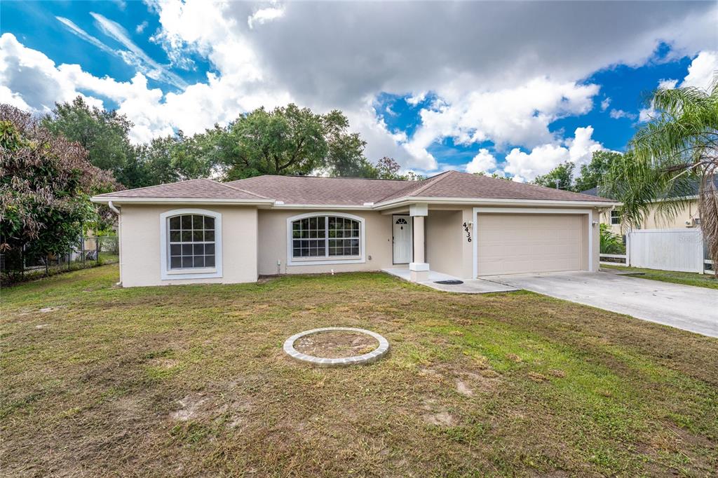 A single-story house with a beige exterior, a two-car garage, and a front lawn — 4436 MAURBACH TERRACE, NORTH PORT, FL