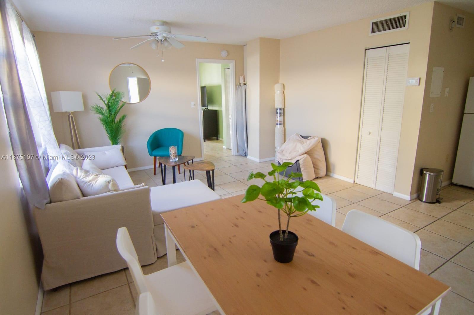 This living and dining area features tile flooring, a ceiling fan, and neutral wall paint — 753 Michigan Ave # 2D, Miami Beach FL 33139, MIAMI BEACH, FL