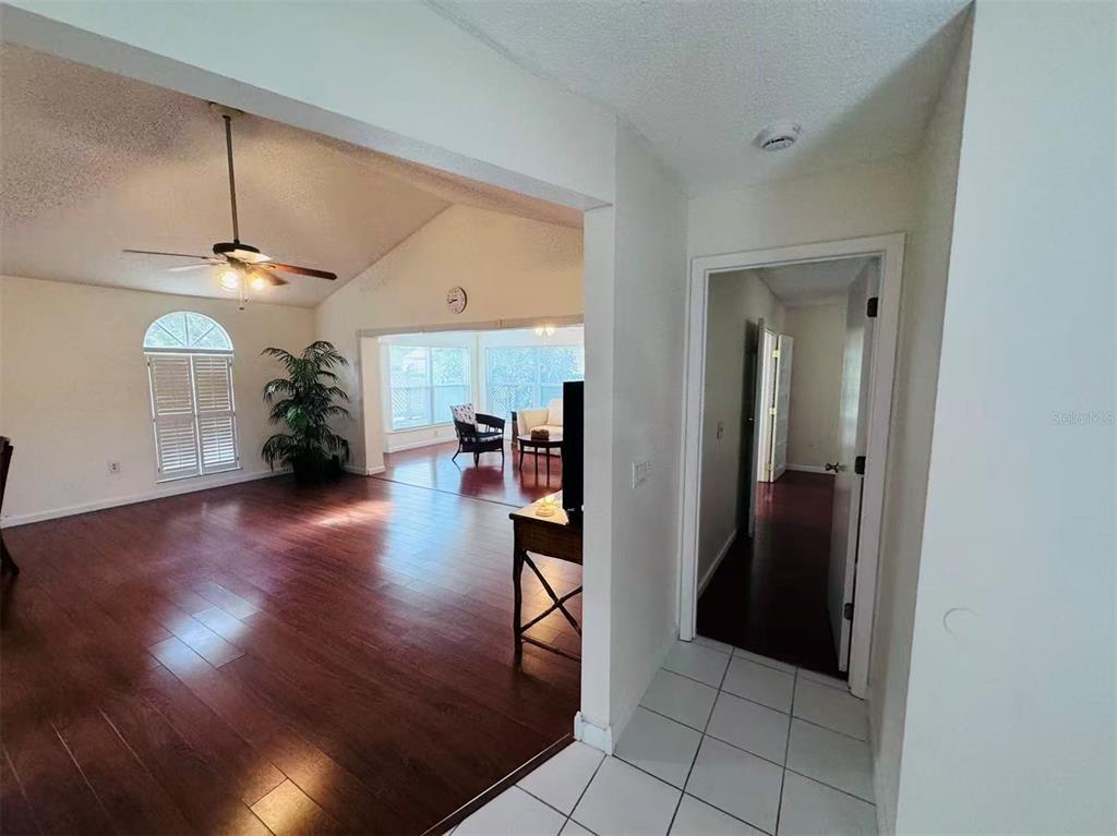 A view from a tiled entryway looking into a living room with hardwood floors — 3605 57TH  AVENUE DR W, BRADENTON, FL