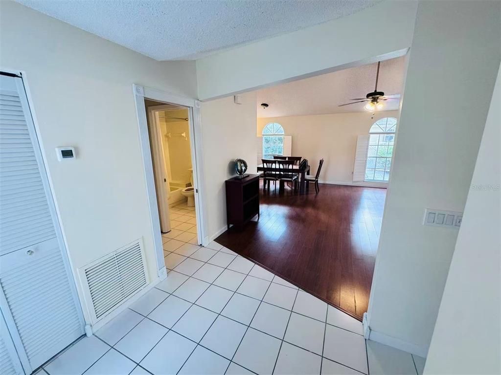 A tiled entryway leads to a dining room with dark wood flooring and arched windows — 3605 57TH  AVENUE DR W, BRADENTON, FL