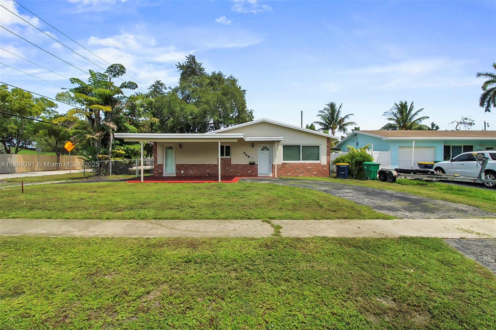 A single-story house with a brick facade, a front carport, and a paved driveway — 846 NW 10th Ave, Dania Beach FL 33004, DANIA BEACH, FL