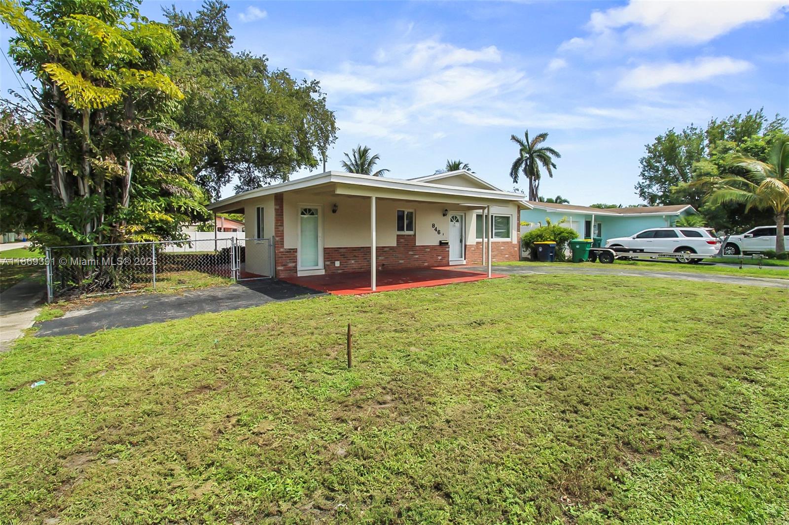 A single-story house with a brick facade, covered porch, and a large front lawn — 846 NW 10th Ave, Dania Beach FL 33004, DANIA BEACH, FL