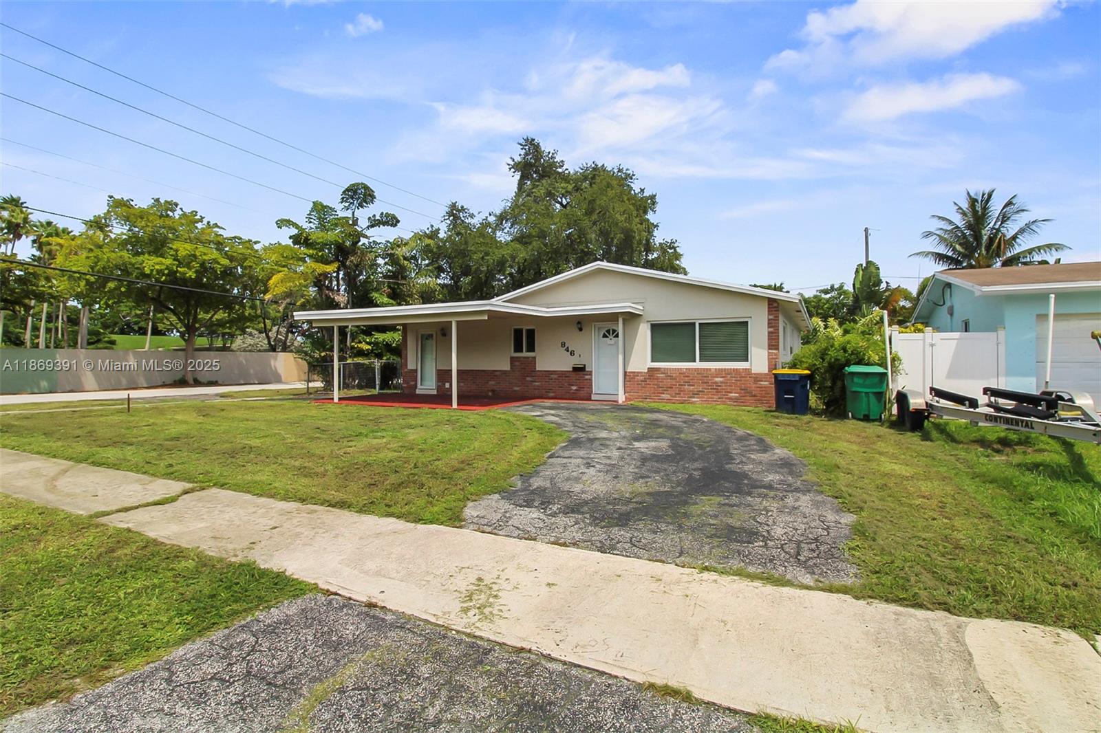 A single-story house with a brick facade, a covered porch, and a paved driveway — 846 NW 10th Ave, Dania Beach FL 33004, DANIA BEACH, FL