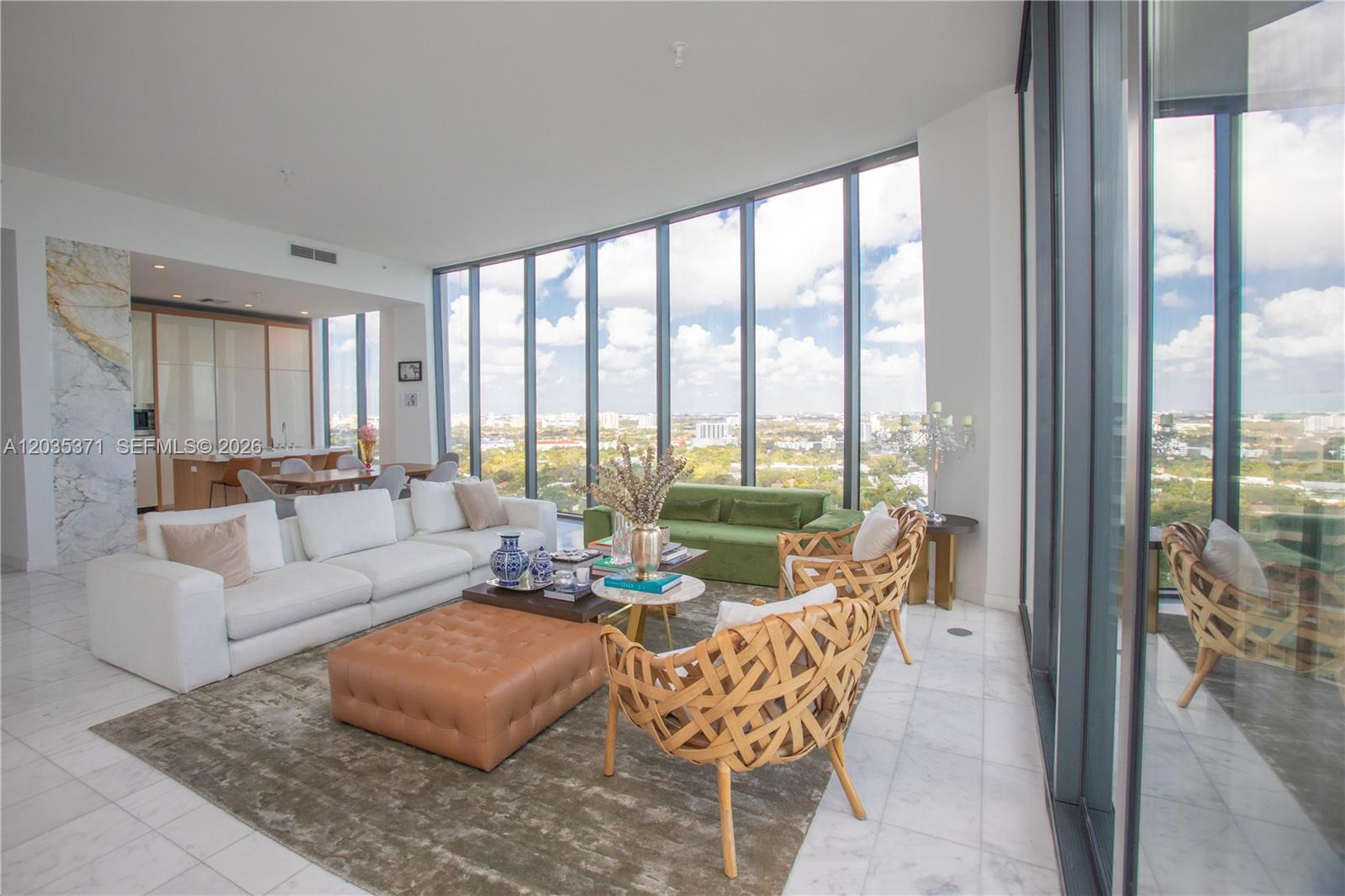 A modern living room features floor-to-ceiling windows, white marble floors, and a panoramic city view — 2821 S Bayshore Dr # 20D, Miami FL 33133, MIAMI, FL