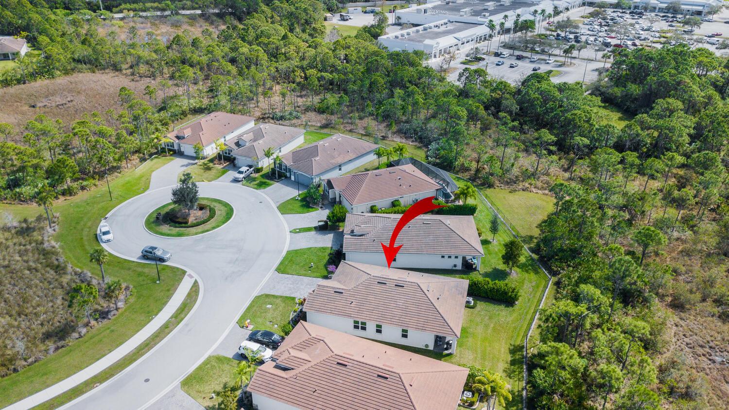 An aerial view shows a suburban neighborhood with houses, a cul-de-sac, and surrounding wooded areas — 4444 NW King Court, Jensen Beach FL 34957, JENSEN BEACH, FL
