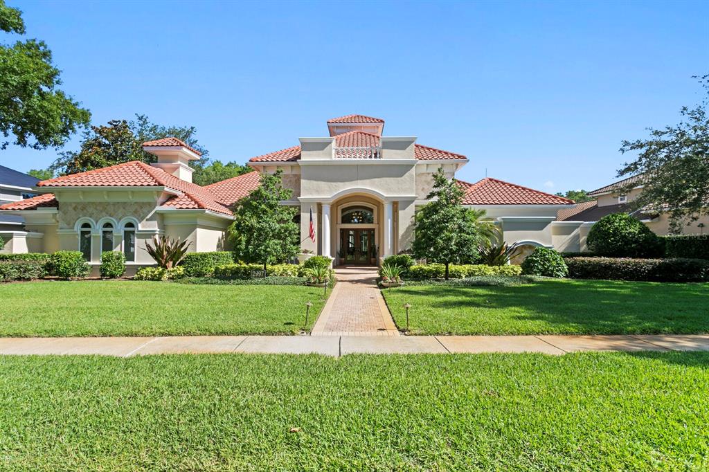 A single-story Mediterranean-style house with a tile roof and a brick walkway — 2997 KENSINGTON TRACE, TARPON SPRINGS, FL
