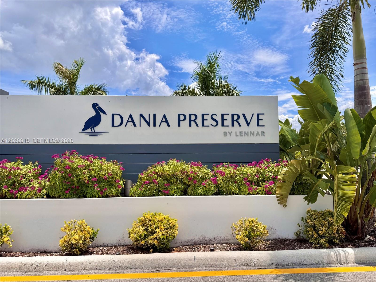 A sign for Dania Preserve by Lennar stands behind a landscaped garden with flowering bushes — 2950 Park Pl # 5838, Dania Beach FL 33312, DANIA BEACH, FL