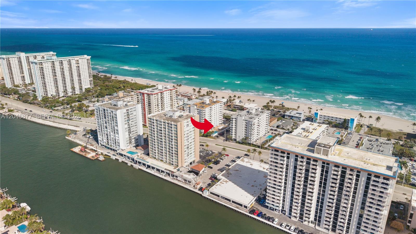 An aerial view shows several high-rise residential buildings situated between a bay and the ocean — 1601 S Ocean Dr # 105, Hollywood FL 33019, HOLLYWOOD, FL