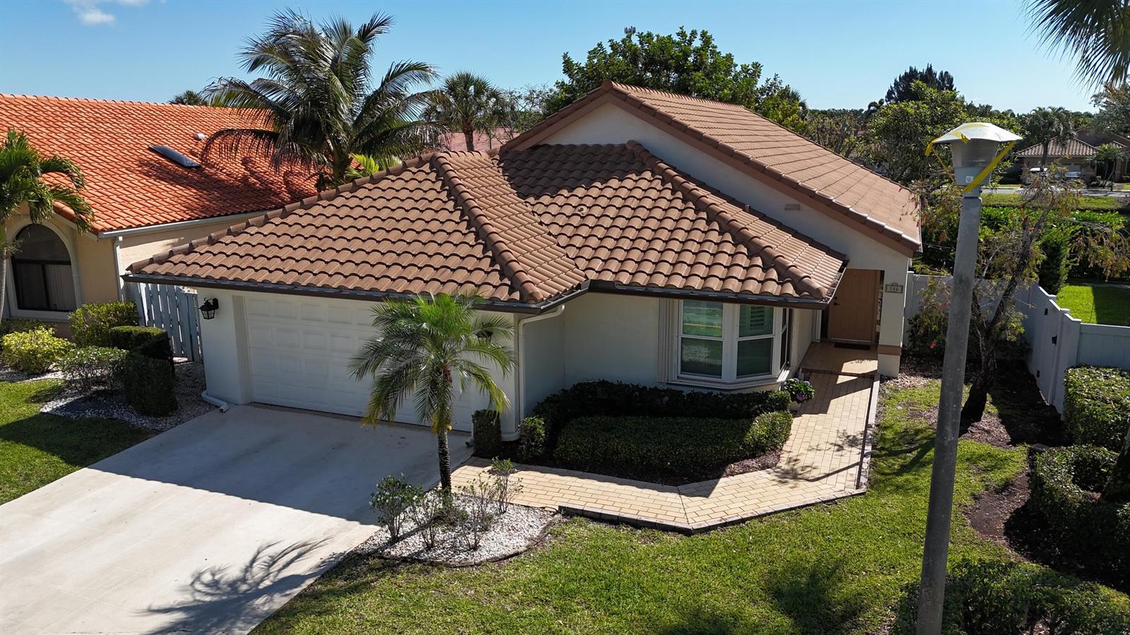 An aerial view of a single-story house with a brown tile roof and driveway — 186 Citrus Trail Circle, Boynton Beach FL 33436, BOYNTON BEACH, FL