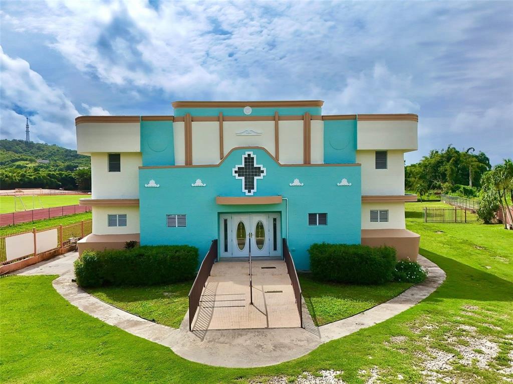 A bright blue, two-story building with a central cross and a ramped entrance — Carr. 760 KM 0.4 BO. EMAJAGUAS, MAUNABO, PR