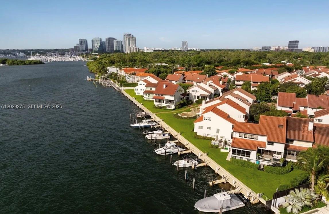 An aerial view shows waterfront townhouses with red tile roofs and private boat slips — 2000 S Bayshore Dr # 58, Miami FL 33133, MIAMI, FL