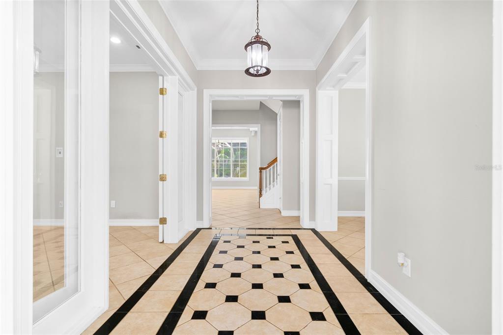 A foyer features a tiled floor with a black and white geometric pattern — 907 WESTPARK DRIVE, CELEBRATION, FL