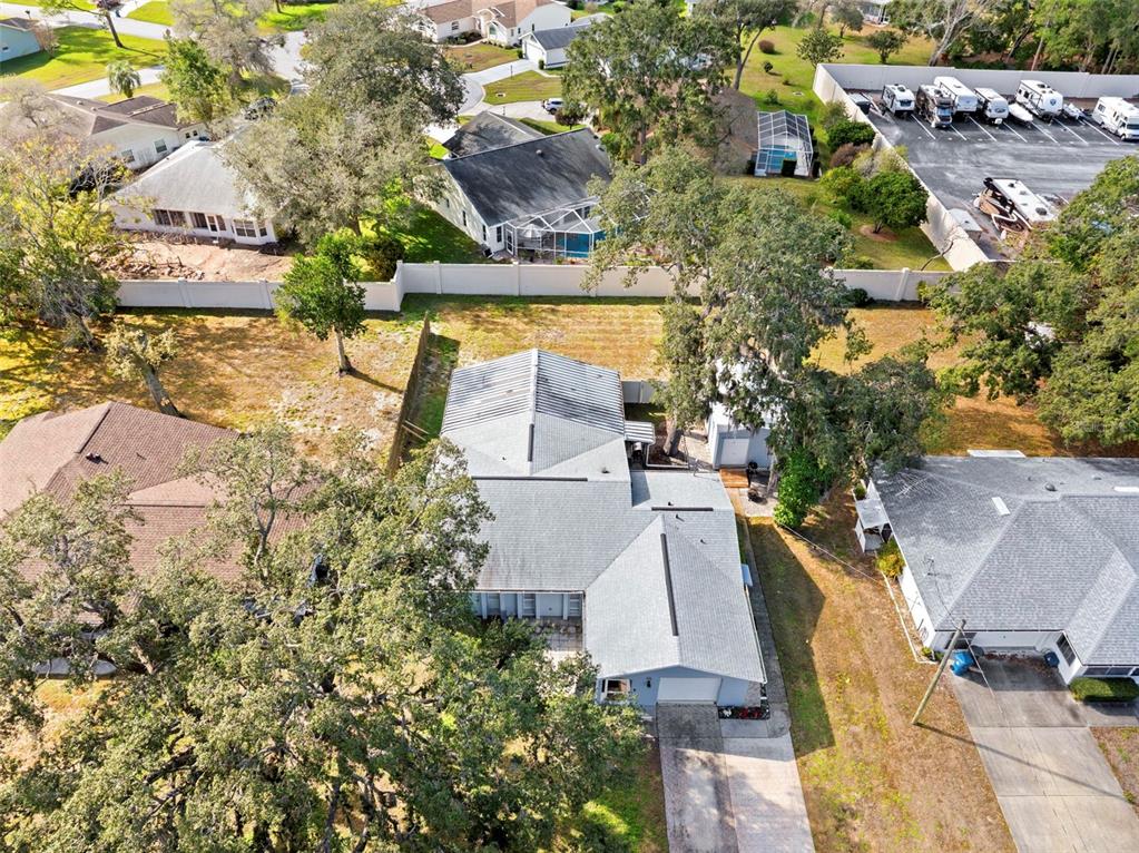An aerial view shows a residential house with a gray roof and a large yard — 2399 GALLAGHER AVENUE, SPRING HILL, FL