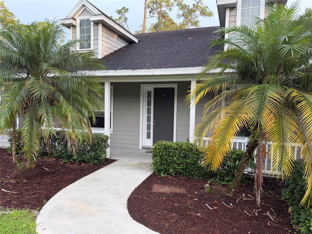 An aerial view shows a single-story house with a dark roof and a concrete driveway — 14412 PINECONE ROAD, ORLANDO, FL