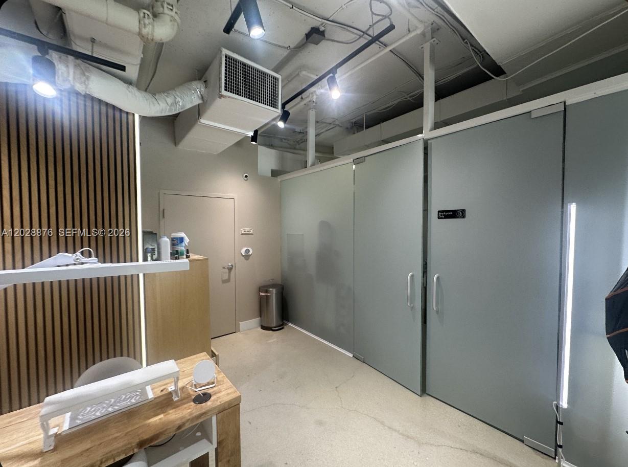 A nail salon features multiple wooden work stations, industrial-style exposed ceilings, and large windows — 1627 SW 37th Ave # 1, Miami FL 33145, MIAMI, FL
