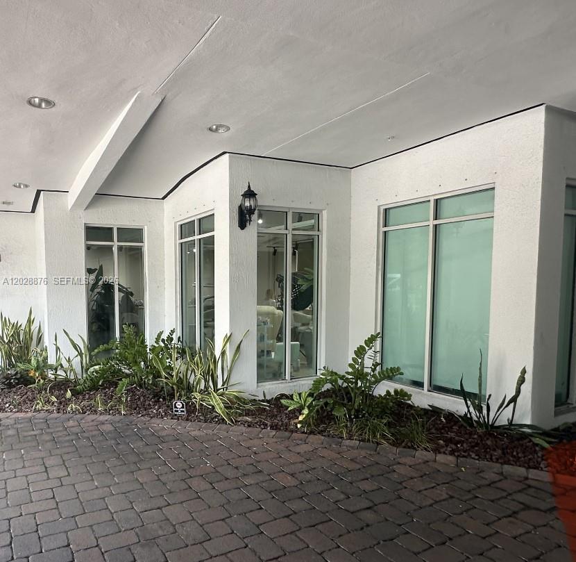 A room features a wooden desk, frosted glass doors, and exposed industrial ceiling fixtures — 1627 SW 37th Ave # 1, Miami FL 33145, MIAMI, FL