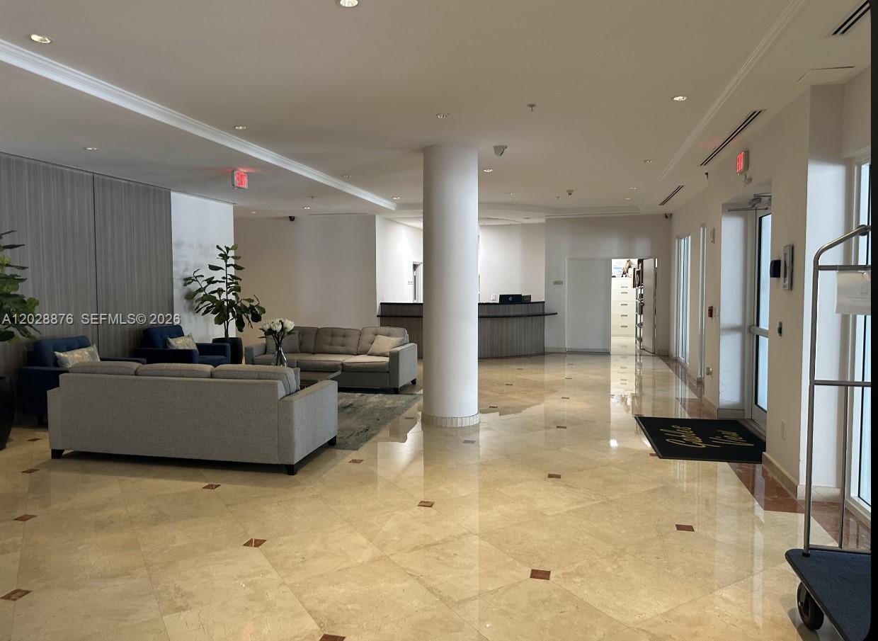 A paved driveway leads to the glass-paned entrance and windows of a commercial building — 1627 SW 37th Ave # 1, Miami FL 33145, MIAMI, FL